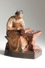 Carved and painted self-portrait of Katharina Kasslatter at a small carving table concentrating on her handiwork