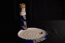 In 'Kakelorum', the marble is thrown into a hollowed-out figurine and lands in the numbered dents in the plate at the bottom.