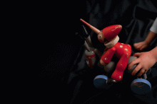 Pinocchio on a donkey with four wheels that moves his legs up and down when pushed